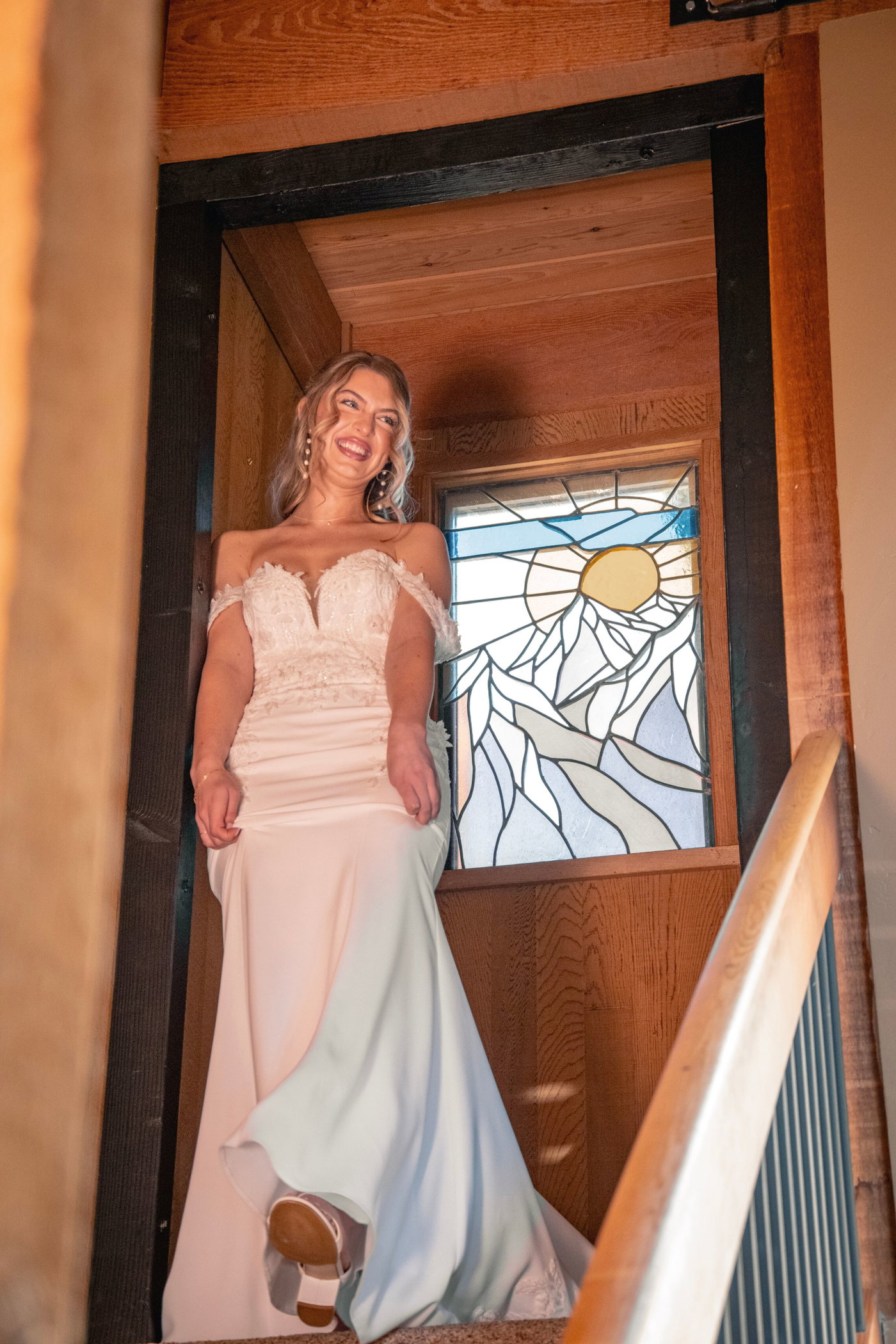 Lillie in the doorway, stained glass behind her