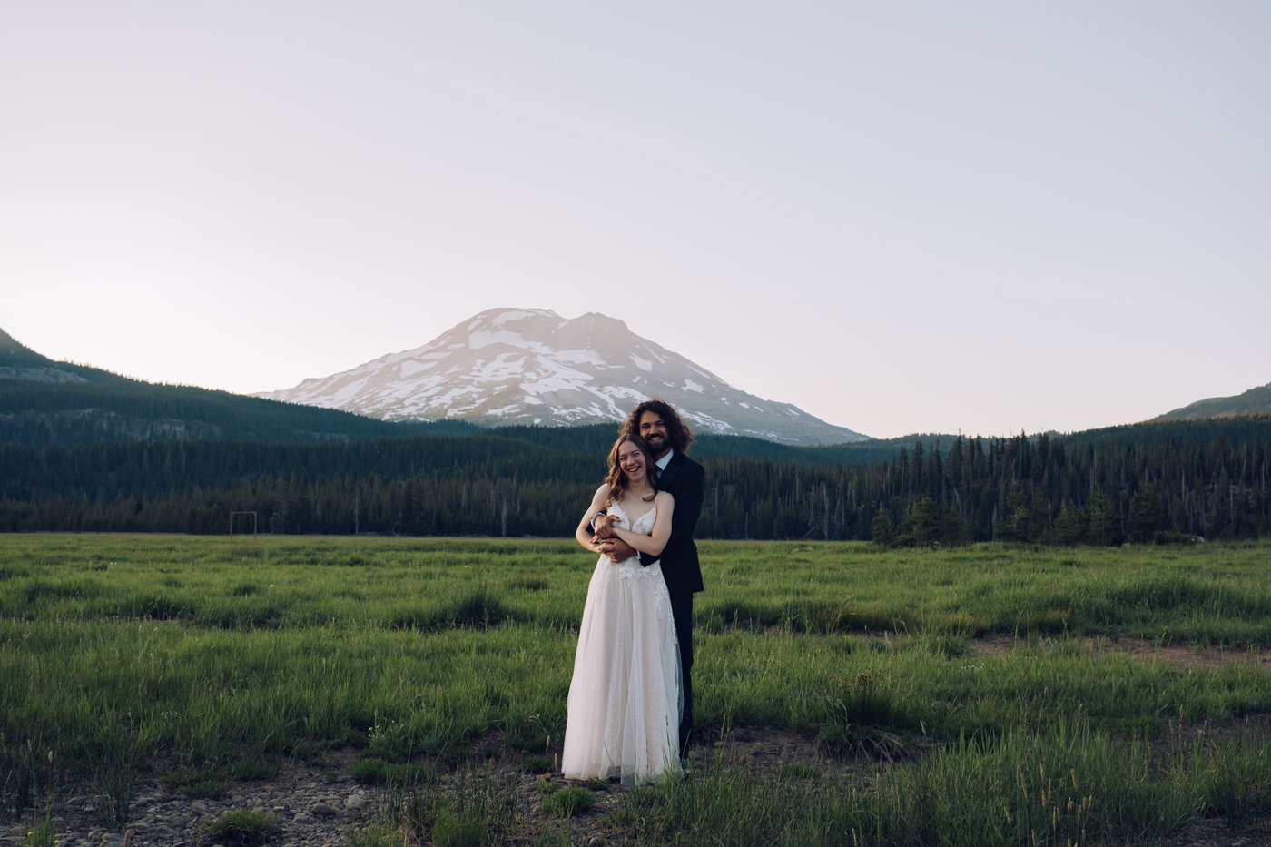 The couple held close, South Sister behind them